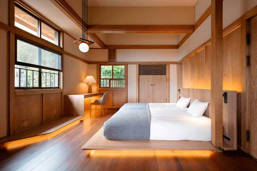 Hotel double room design with wooden platform bed.