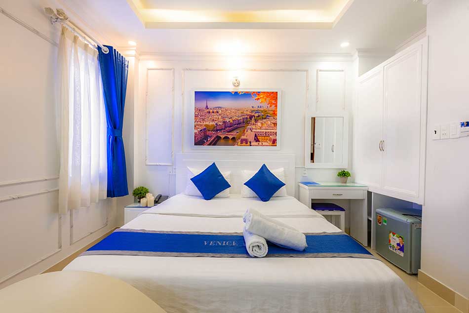 White and blue color double hotel room.